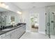 Spacious bathroom with double vanity, framed mirror, and glass shower enclosure at 1609 Garden Park Cir, Fuquay Varina, NC 27526