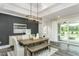 Elegant dining room with a wooden table and sliding glass doors to a porch at 1609 Garden Park Cir, Fuquay Varina, NC 27526