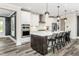 Modern eat-in kitchen with white cabinets, marble counters, and bar stool seating at 1609 Garden Park Cir, Fuquay Varina, NC 27526