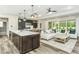 Open-concept living space features a large island and modern finishes at 1609 Garden Park Cir, Fuquay Varina, NC 27526