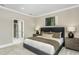 Cozy bedroom featuring an upholstered headboard, neutral paint, and soft carpet at 1609 Garden Park Cir, Fuquay Varina, NC 27526