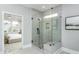 Modern glass shower featuring a tiled surround, corner bench, and window at 1609 Garden Park Cir, Fuquay Varina, NC 27526