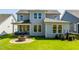 Exterior view of the home's back, showcasing the patio and spacious backyard at 1610 Garden Park Cir, Fuquay Varina, NC 27526