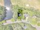 Aerial view of the house and its lot surrounded by trees, a pond and a golf course at 1913 Wild Dunes Dr, Raleigh, NC 27604