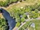 Aerial view of the house near a pond and a golf course, surrounded by lush greenery at 1913 Wild Dunes Dr, Raleigh, NC 27604