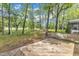 Home's backyard features a wooden deck with a bench, trees and grass at 1913 Wild Dunes Dr, Raleigh, NC 27604