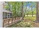 Expansive backyard view from a screened porch and wood deck with plenty of mature trees at 1913 Wild Dunes Dr, Raleigh, NC 27604
