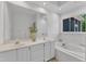 Bright bathroom with double sinks, a soaking tub, and white tile at 1913 Wild Dunes Dr, Raleigh, NC 27604