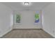 Bright bedroom features white walls, carpet floors, trim and two windows looking out to the backyard at 1913 Wild Dunes Dr, Raleigh, NC 27604