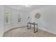 Bright bedroom featuring two windows, carpet floors and black desk with modern accents at 1913 Wild Dunes Dr, Raleigh, NC 27604