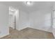 Carpeted bedroom with white walls, ceiling trim and an opening to another room at 1913 Wild Dunes Dr, Raleigh, NC 27604