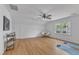 Bright bonus room featuring hardwood floors, ceiling fan, large window and door for access at 1913 Wild Dunes Dr, Raleigh, NC 27604