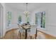 Bright dining room featuring a chandelier, table setting, and multiple windows at 1913 Wild Dunes Dr, Raleigh, NC 27604