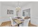 Formal dining room with a chandelier, table setting, and elegant white chairs at 1913 Wild Dunes Dr, Raleigh, NC 27604