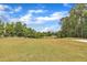 View of expansive and well-maintained golf course with mature trees and blue sky at 1913 Wild Dunes Dr, Raleigh, NC 27604