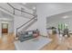 Open-concept living room with high ceilings, a staircase, and a view of the kitchen and dining area at 1913 Wild Dunes Dr, Raleigh, NC 27604