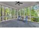Screened-in porch with a ceiling fan and views to the wooded backyard at 1913 Wild Dunes Dr, Raleigh, NC 27604