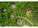 Stunning aerial view of a wooded community showcasing houses nestled among lush greenery and winding roads at 201 Summergate Cir, Chapel Hill, NC 27516
