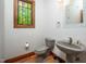 Cozy powder room featuring natural wood accents and a pedestal sink, perfect for guests at 201 Summergate Cir, Chapel Hill, NC 27516