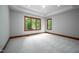 Bedroom featuring tray ceiling, recessed lights, and a large window with backyard views at 201 Summergate Cir, Chapel Hill, NC 27516