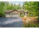 Home exterior showcasing stone accents, a two-car garage, and an extended driveway at 201 Summergate Cir, Chapel Hill, NC 27516