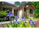 Landscaped front with purple Iris flowers adding colorful foreground to this beautiful home at 201 Summergate Cir, Chapel Hill, NC 27516