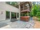 Backyard patio with a hot tub and easy access to a screened porch and large sliding glass doors at 201 Summergate Cir, Chapel Hill, NC 27516
