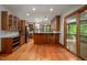 Kitchen boasting wooden cabinets, stainless steel appliances, and access to an outdoor patio at 201 Summergate Cir, Chapel Hill, NC 27516