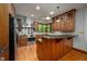 Kitchen featuring wooden cabinets, granite countertops, stainless steel appliances, and tiled backsplash at 201 Summergate Cir, Chapel Hill, NC 27516