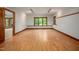 Room featuring wood floors, wood trim, and abundant natural light with entry to another room at 201 Summergate Cir, Chapel Hill, NC 27516