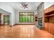 Open living room boasts hardwood floors, stone fireplace, large windows, and built-in shelves at 201 Summergate Cir, Chapel Hill, NC 27516