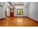 Bright and airy living room with hardwood floors, natural lighting, and a stylish front door at 201 Summergate Cir, Chapel Hill, NC 27516