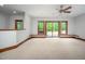 Bright living room featuring a ceiling fan, neutral carpet, and sliding glass doors leading to the outdoors at 201 Summergate Cir, Chapel Hill, NC 27516