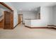 Carpeted living room with wood trim, open doorway, and natural light, perfect for relaxation at 201 Summergate Cir, Chapel Hill, NC 27516