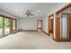 Spacious living room offering wood trim windows, neutral carpet, ceiling fan, and recessed lighting at 201 Summergate Cir, Chapel Hill, NC 27516