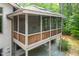 This large screened-in porch features a ceiling fan and a view of the wooded lot at 201 Summergate Cir, Chapel Hill, NC 27516