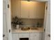 A convenient bar area is shown, with cabinets, sink, storage and neutral tones at 202 Selkirk Pl, Durham, NC 27707