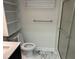 An updated bathroom shows gray-veined marble-like flooring, a vanity, a commode, and a glass shower at 202 Selkirk Pl, Durham, NC 27707