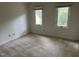Bright bedroom with carpet flooring and natural light from the two windows at 202 Selkirk Pl, Durham, NC 27707