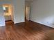 An open bedroom with wood floors is visible leading to the en-suite bath at 202 Selkirk Pl, Durham, NC 27707