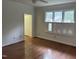 Primary bedroom boasts hardwood floors, a closet, and lots of bright, natural light at 202 Selkirk Pl, Durham, NC 27707