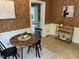 Charming breakfast nook featuring a round table, stylish wallpaper, and convenient bar cart at 202 Selkirk Pl, Durham, NC 27707