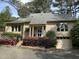 Charming brick home with landscaped front yard, mature trees, and inviting entryway at 202 Selkirk Pl, Durham, NC 27707