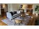 Cozy living room featuring hardwood floors, plush seating, and access to dining area at 202 Selkirk Pl, Durham, NC 27707