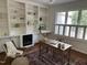Bright office space featuring custom built-ins, fireplace, and a window with shutters at 202 Selkirk Pl, Durham, NC 27707