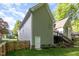 Back exterior of a charming home featuring a fenced yard and wooden deck with stairs at 216 Billingrath Turn Ln, Cary, NC 27519