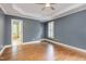 Spacious bedroom with tray ceiling, ceiling fan, and hardwood floors at 216 Billingrath Turn Ln, Cary, NC 27519