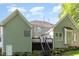 View of rear exterior with a deck, stairs to yard and partial brick foundation at 216 Billingrath Turn Ln, Cary, NC 27519