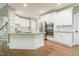 Well-equipped kitchen with granite island, stainless-steel appliances, and white cabinetry at 216 Billingrath Turn Ln, Cary, NC 27519