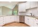 Bright kitchen features granite countertops, white cabinets, and stainless-steel appliances at 216 Billingrath Turn Ln, Cary, NC 27519